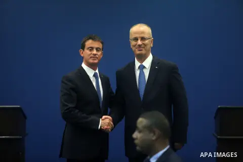 French Prime Minister Manuel Valls and Palestinian prime minister Rami Hamdallah shake hands during a meeting in the West Bank city of Ramallah, on May 24, 2016. Palestinian prime minister Rami Hamdallah dismissed an Isr...