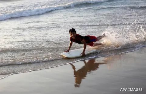 Palestinian youths enjoy a day at the beach of the Mediterranean sea on the coast of Gaza city during sunset, on May 24, 2016. Photo by Mohammed Asad