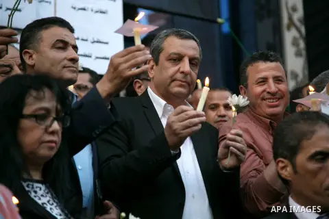 Egyptian journalists hold candles and placards supporting EgyptAir during a candlelight vigil for the victims of EgyptAir flight 804 in front of the Journalists' Syndicate in Cairo, Egypt, on May 24, 2016. The cause of T...