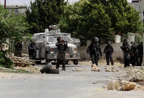 Israeli security forces aim at Palestinian protesters during clashes following a demonstration against the expropriation of Palestinian land by Israel, on May 27, 2016 in the village of Kfar Qaddum, near Nablus, in the o...