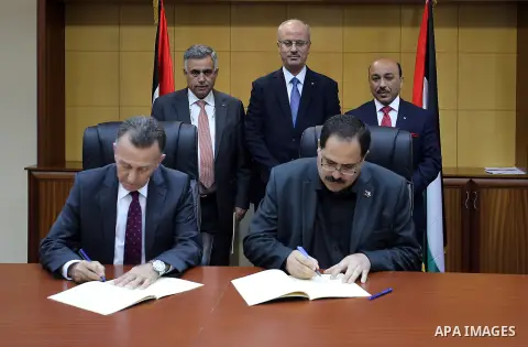 Palestinian Prime minister Rami Hamdallah attends the Signing an agreement between the Ministries of Local Government and Education and Islamic Bank, in the West bank city of Ramallah on May 31, 2016. Photo by Prime Mini...