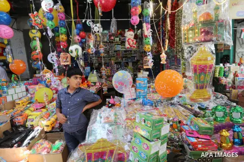 A Palestinian vendor displays a traditional lantern known in Arabic as "Fanous" and toys in a market in Gaza city as the faithful prepare for the start of the Muslim holy fasting month of Ramadan on May 31, 2016. More th...