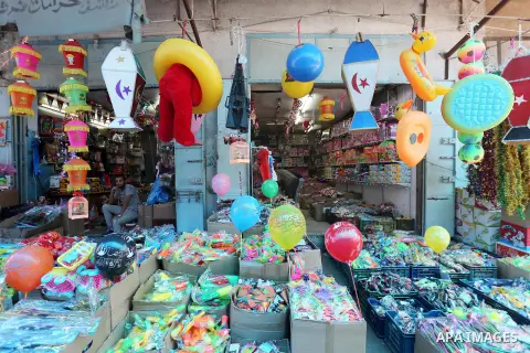 A Palestinian vendor displays a traditional lantern known in Arabic as "Fanous" and toys in a market in Gaza city as the faithful prepare for the start of the Muslim holy fasting month of Ramadan on May 31, 2016. More th...