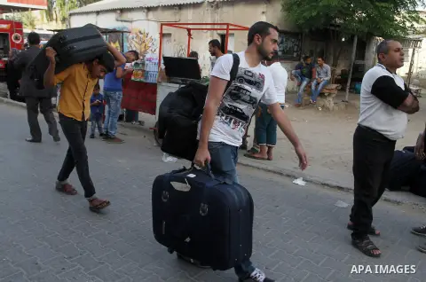 Palestinians wait for travel permits to cross into Egypt through the Rafah border crossing after it was opened for four days by Egyptian authorities, in the southern Gaza Strip June 1, 2016. Photo by Abed Rahim Khatib