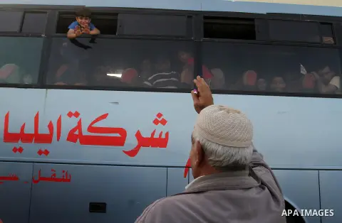 Palestinians wait for travel permits to cross into Egypt through the Rafah border crossing after it was opened for four days by Egyptian authorities, in the southern Gaza Strip June 1, 2016. Photo by Abed Rahim Khatib