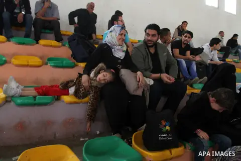 Palestinians wait for travel permits to cross into Egypt through the Rafah border crossing after it was opened for four days by Egyptian authorities, in the southern Gaza Strip June 1, 2016. Photo by Abed Rahim Khatib