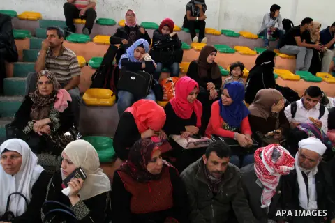Palestinians wait for travel permits to cross into Egypt through the Rafah border crossing after it was opened for four days by Egyptian authorities, in the southern Gaza Strip June 1, 2016. Photo by Abed Rahim Khatib