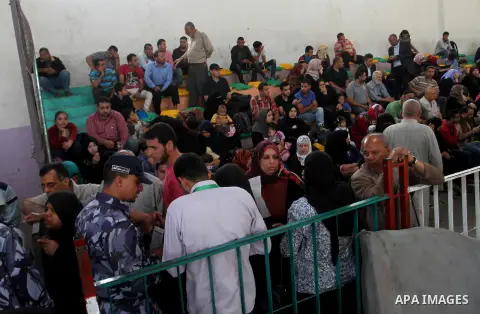 Palestinians wait for travel permits to cross into Egypt through the Rafah border crossing after it was opened for four days by Egyptian authorities, in the southern Gaza Strip June 1, 2016. Photo by Abed Rahim Khatib