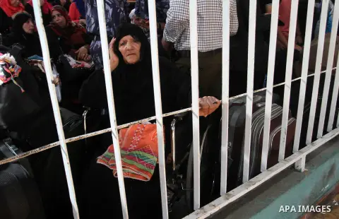 Palestinians wait for travel permits to cross into Egypt through the Rafah border crossing after it was opened for four days by Egyptian authorities, in the southern Gaza Strip June 1, 2016. Photo by Abed Rahim Khatib