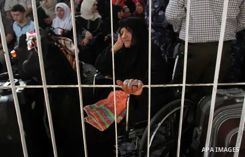 Palestinians wait for travel permits to cross into Egypt through the Rafah border crossing after it was opened for four days by Egyptian authorities, in the southern Gaza Strip June 1, 2016. Photo by Abed Rahim Khatib