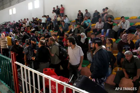 Palestinians wait for travel permits to cross into Egypt through the Rafah border crossing after it was opened for four days by Egyptian authorities, in the southern Gaza Strip June 1, 2016. Photo by Abed Rahim Khatib