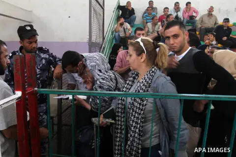 Palestinians wait for travel permits to cross into Egypt through the Rafah border crossing after it was opened for four days by Egyptian authorities, in the southern Gaza Strip June 1, 2016. Photo by Abed Rahim Khatib