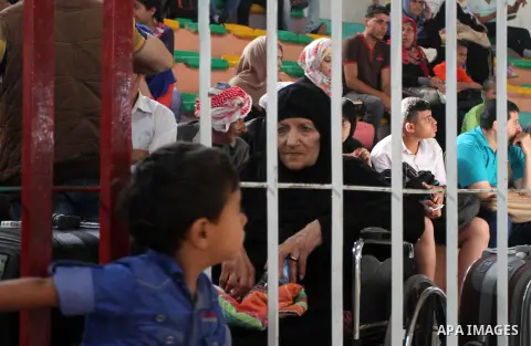 Palestinians wait for travel permits to cross into Egypt through the Rafah border crossing after it was opened for four days by Egyptian authorities, in the southern Gaza Strip June 1, 2016. Photo by Abed Rahim Khatib