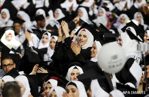 Palestinian students attend their graduation ceremony at the end of the academic year on June 01, 2016 at Hebron University in the West Bank city of Hebron. Photo by Wisam Hashlamoun