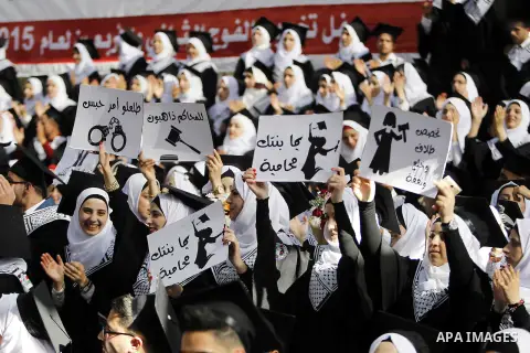 Palestinian students attend their graduation ceremony at the end of the academic year on June 01, 2016 at Hebron University in the West Bank city of Hebron. Photo by Wisam Hashlamoun