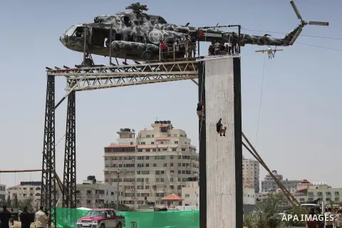 Member of Palestinian security forces display their skills during a military graduation ceremony in Gaza City June 2, 2016. Photo by Mohammed Asad