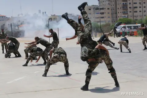 Member of Palestinian security forces display their skills during a military graduation ceremony in Gaza City June 2, 2016. Photo by Mohammed Asad