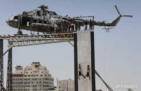 Member of Palestinian security forces display their skills during a military graduation ceremony in Gaza City June 2, 2016. Photo by Mohammed Asad