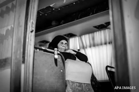 A Palestinian woman waits for travel permit to cross into Egypt through the Rafah border crossing after it was opened for four days by Egyptian authorities, in the southern Gaza Strip June 02, 2016. Photo by Mohammed Dah...