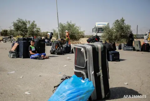Palestinians wait for travel permits to cross into Egypt through the Rafah border crossing after it was opened for four days by Egyptian authorities, in the southern Gaza Strip June 02, 2016. Photo by Mohammed Dahman