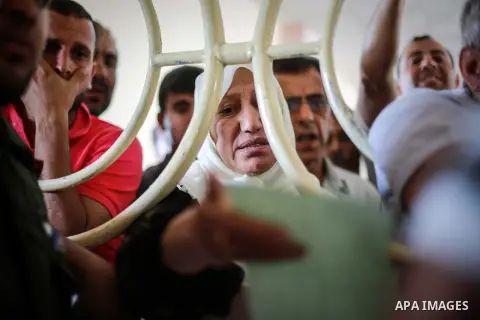 Palestinians wait for travel permits to cross into Egypt through the Rafah border crossing after it was opened for four days by Egyptian authorities, in the southern Gaza Strip June 02, 2016. Photo by Mohammed Dahman