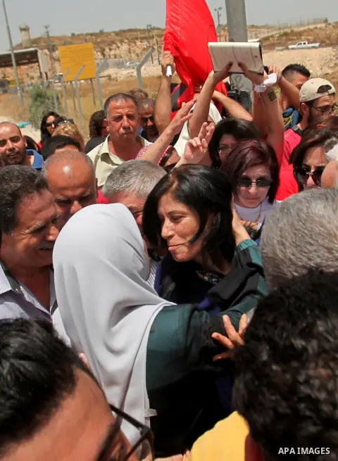 Prominent Palestinian lawmaker Khalida Jarrar hugs a supporter at the Jubara checkpoint near the northern West Bank city of Tulkarem, following her release from an Israeli jail on June 3, 2016, after serving a 15-month s...