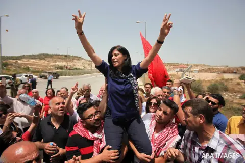 Prominent Palestinian lawmaker Khalida Jarrar is lifted up by supporters at the Jubara checkpoint near the northern West Bank city of Tulkarem, following her release from an Israeli jail on June 3, 2016, after serving a...