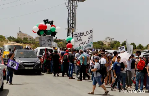 Palestinian and Israeli activists take part in a demonstration in support of peace near the West Bank city of Bethlehem June 3, 2016. Photo by Wisam Hashlamoun