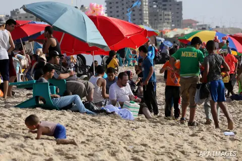 Palestinians enjoy a day at the beach of the Mediterranean sea on the coast of Gaza city, on June 03, 2016 on the last Friday before the Islamic holy month of Ramadan. Photo by Mohammed Asad