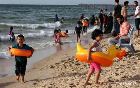 Palestininas swim in the Mediterranean sea on the coast of Gaza city, on June 03, 2016 on the last Friday before the Islamic holy month of Ramadan. Photo by Mohammed Asad