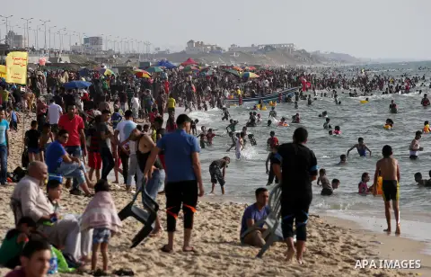 Palestininas swim in the Mediterranean sea on the coast of Gaza city, on June 03, 2016 on the last Friday before the Islamic holy month of Ramadan. Photo by Mohammed Asad