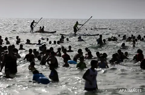Palestininas swim in the Mediterranean sea on the coast of Gaza city, on June 03, 2016 on the last Friday before the Islamic holy month of Ramadan. Photo by Mohammed Asad