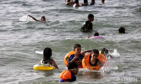 Palestininas swim in the Mediterranean sea on the coast of Gaza city, on June 03, 2016 on the last Friday before the Islamic holy month of Ramadan. Photo by Mohammed Asad