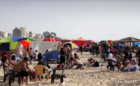 Palestinians enjoy a day at the beach of the Mediterranean sea on the coast of Gaza city, on June 03, 2016 on the last Friday before the Islamic holy month of Ramadan. Photo by Mohammed Asad