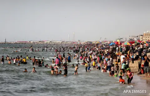 Palestininas swim in the Mediterranean sea on the coast of Gaza city, on June 03, 2016 on the last Friday before the Islamic holy month of Ramadan. Photo by Mohammed Asad