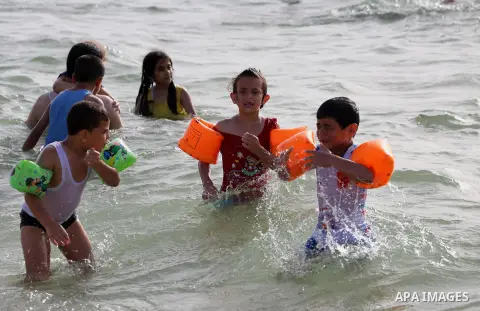 Palestininas swim in the Mediterranean sea on the coast of Gaza city, on June 03, 2016 on the last Friday before the Islamic holy month of Ramadan. Photo by Mohammed Asad