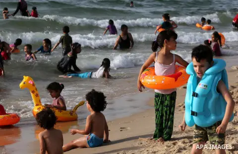 Palestininas swim in the Mediterranean sea on the coast of Gaza city, on June 03, 2016 on the last Friday before the Islamic holy month of Ramadan. Photo by Mohammed Asad