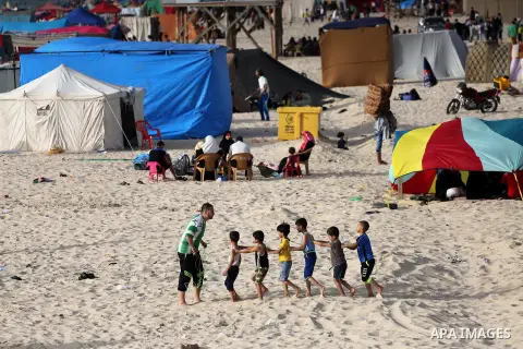 Palestinians enjoy a day at the beach of the Mediterranean sea on the coast of Gaza city, on June 03, 2016 on the last Friday before the Islamic holy month of Ramadan. Photo by Mohammed Asad