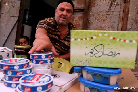 Palestinians shop at a traditional market in preparation for the holy month of Ramadan in Rafah in the southern Gaza strip on June 4,2016. Muslims around the world refrain from eating, drinking and sexual intercourse fro...
