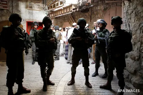 Israeli troops guard Israeli settlers during their weekly tour through the Old City of West Bank city of Hebron, 04 June 2016. Every Saturday a tour through Hebron's Old City, which is usually off limits for Israeli sett...