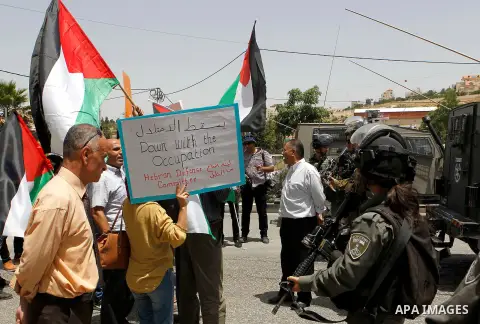 Palestinians take part in a demonstration to mark Naksa Day (setback), in the West Bank city of Hebron, on June 04, 2016. Palestinians mark "Naksa Day" to mourn the 49th anniversary of Israel's occupation of the West Ban...