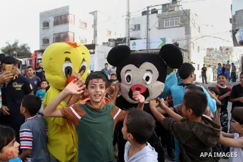 Palestinian children take part in a street celebration ahead of the beginning of the Muslim holy month of Ramadan in Rafah in the southern Gaza strip on June 5, 2016. More than 1.5 billion Muslims around the world will s...
