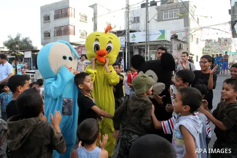Palestinian children take part in a street celebration ahead of the beginning of the Muslim holy month of Ramadan in Rafah in the southern Gaza strip on June 5, 2016. More than 1.5 billion Muslims around the world will s...