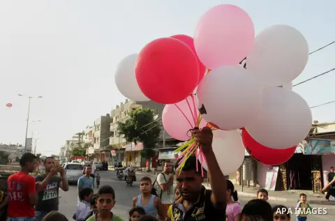 Palestinian children take part in a street celebration ahead of the beginning of the Muslim holy month of Ramadan in Rafah in the southern Gaza strip on June 5, 2016. More than 1.5 billion Muslims around the world will s...