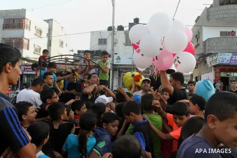 Palestinian children take part in a street celebration ahead of the beginning of the Muslim holy month of Ramadan in Rafah in the southern Gaza strip on June 5, 2016. More than 1.5 billion Muslims around the world will s...
