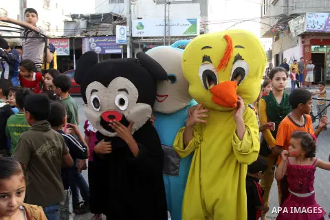 Palestinian children take part in a street celebration ahead of the beginning of the Muslim holy month of Ramadan in Rafah in the southern Gaza strip on June 5, 2016. More than 1.5 billion Muslims around the world will s...