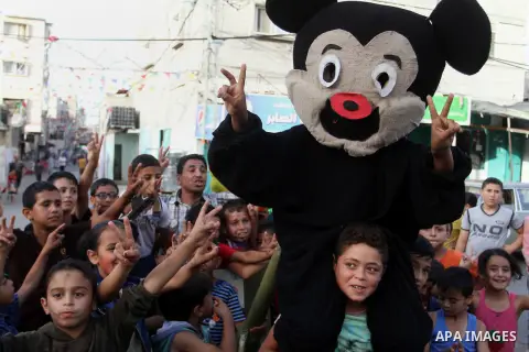 Palestinian children take part in a street celebration ahead of the beginning of the Muslim holy month of Ramadan in Rafah in the southern Gaza strip on June 5, 2016. More than 1.5 billion Muslims around the world will s...