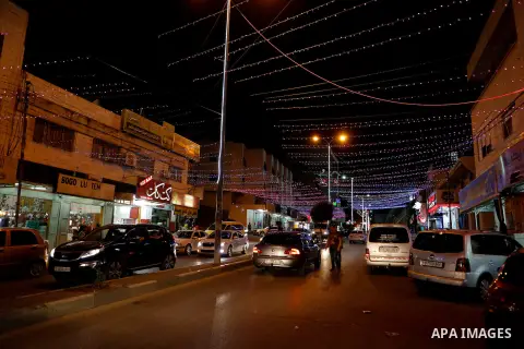 Palestinians walk at street under hang up decorations ahead of the beginning of the Muslim holy month of Ramadan in the West bank city of Hebron, on June 05, 2016. More than 1.5 billion Muslims around the world will star...