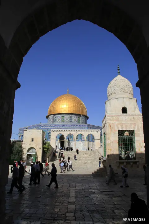 Palestinians Muslims walk walk in front of the Dome of the Rock mosque, in Jerusalem's old city on June 6, 2016 on the first day of the Ramadan,. More than 1.5 billion Muslims around the world will start to celebrate Ram...