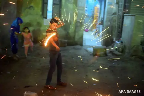 An Egyptian boy plays with fire crackers celebrating ahead of the Muslim holy month of Ramadan in Cairo, Egypt, on June 06, 2016. Ramadan is sacred to Muslims because it is during that month that tradition says the Koran...